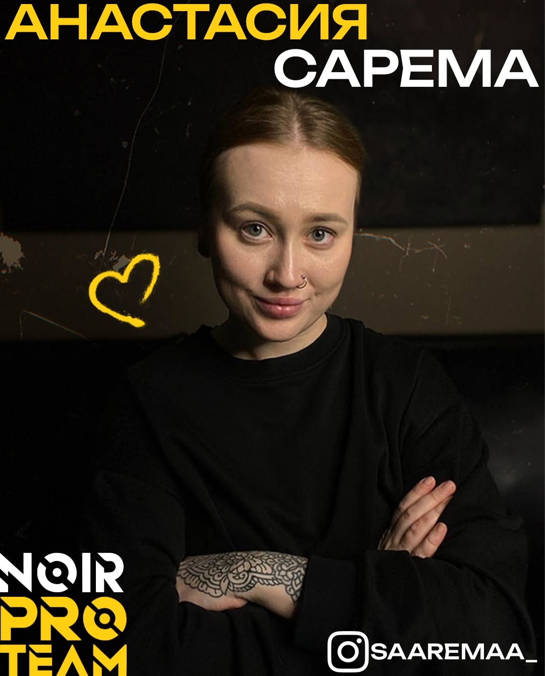 Woman wearing black shirt displaying an ornamental mandala-patterned tattoo on her wrist in black ink.