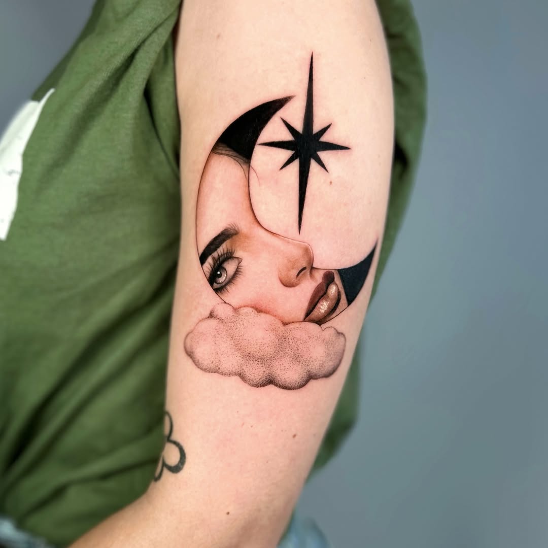 Tattoo on upper arm featuring a profile of a face on a cloud with a crescent moon and eight-pointed star above, rendered in black and tan ink.