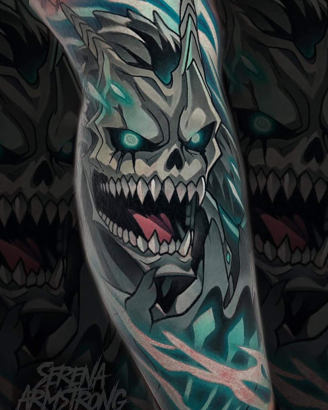 Skull tattoo with glowing teal eyes, sharp teeth, and geometric teal and gray patterns on the forearm, created by Serena Armstrong.