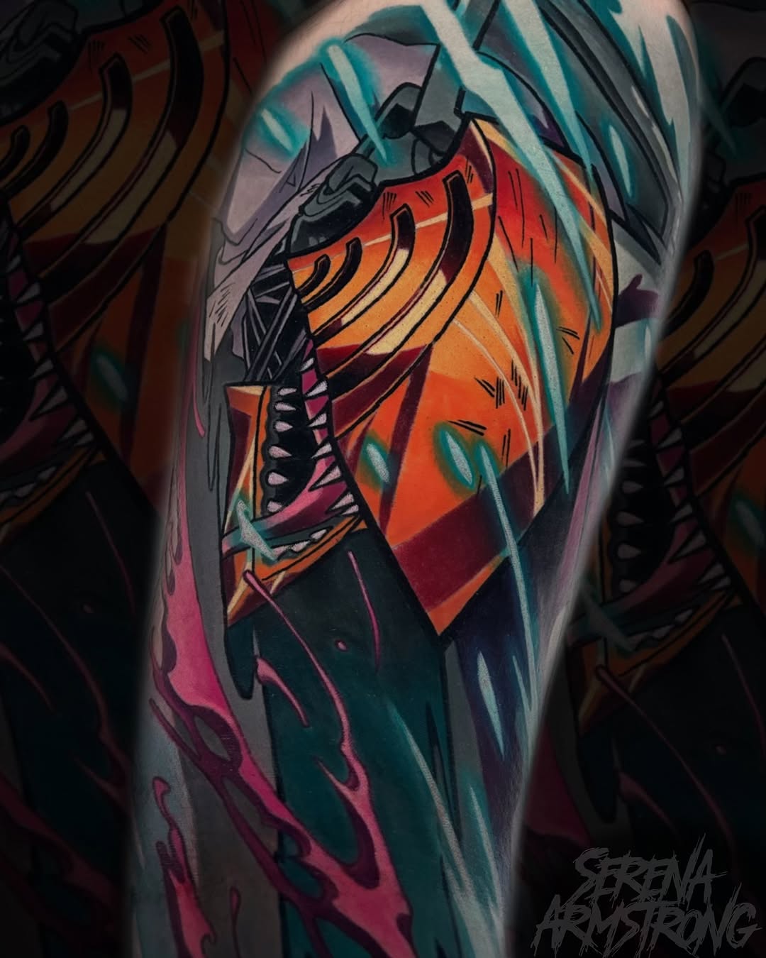 Colorful anatomical heart tattoo on upper arm featuring orange, red, teal, and black shading with detailed line work and geometric elements.