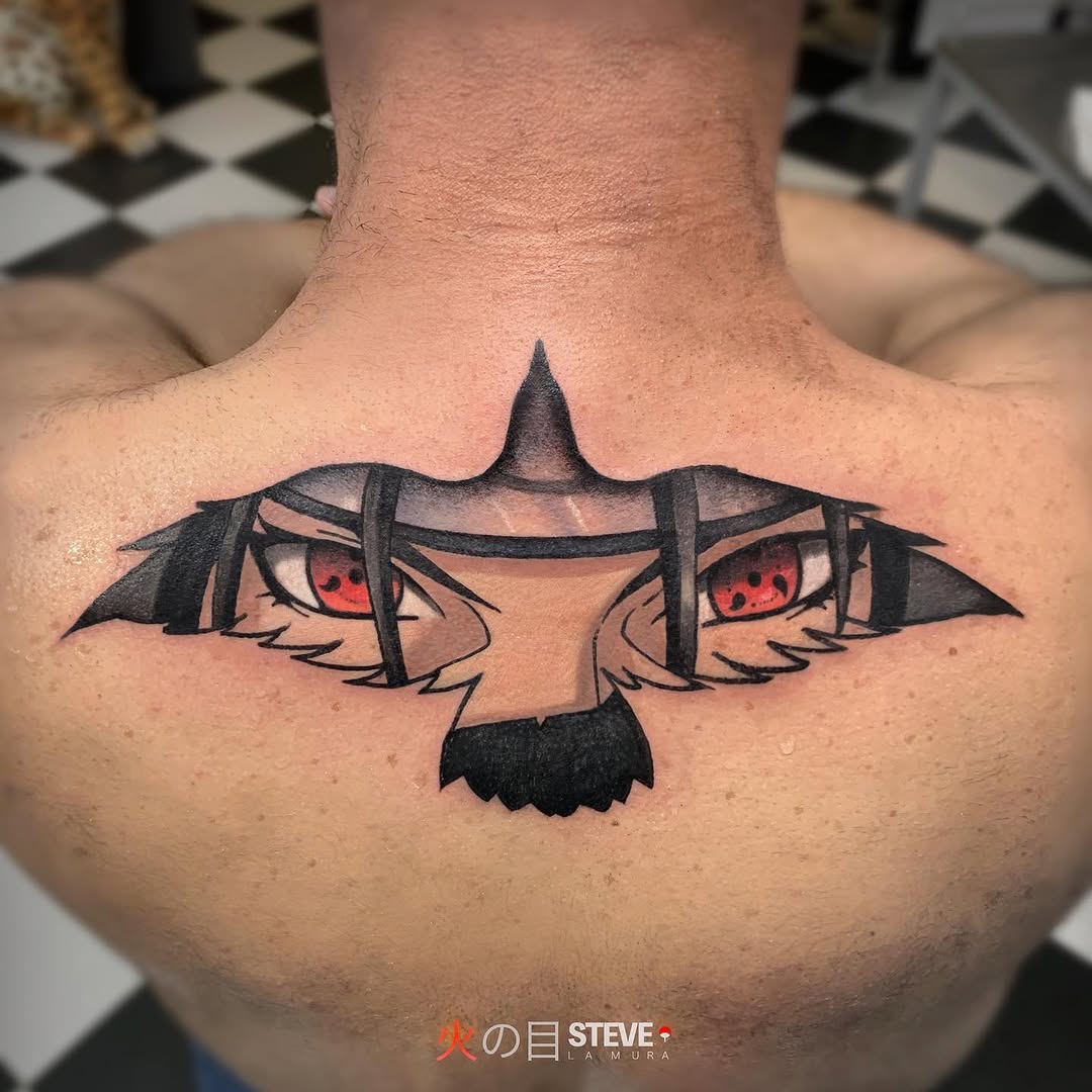 Chest tattoo featuring a stylized bird with spread wings, red eyes, and black straps crossing through the design, centered on the upper back.