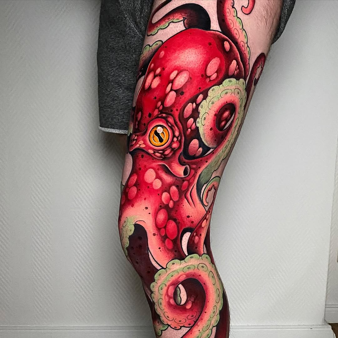 Full-leg tattoo sleeve featuring vibrant red octopus with yellow eye, green tentacle details, and pink circular patterns from thigh to ankle.