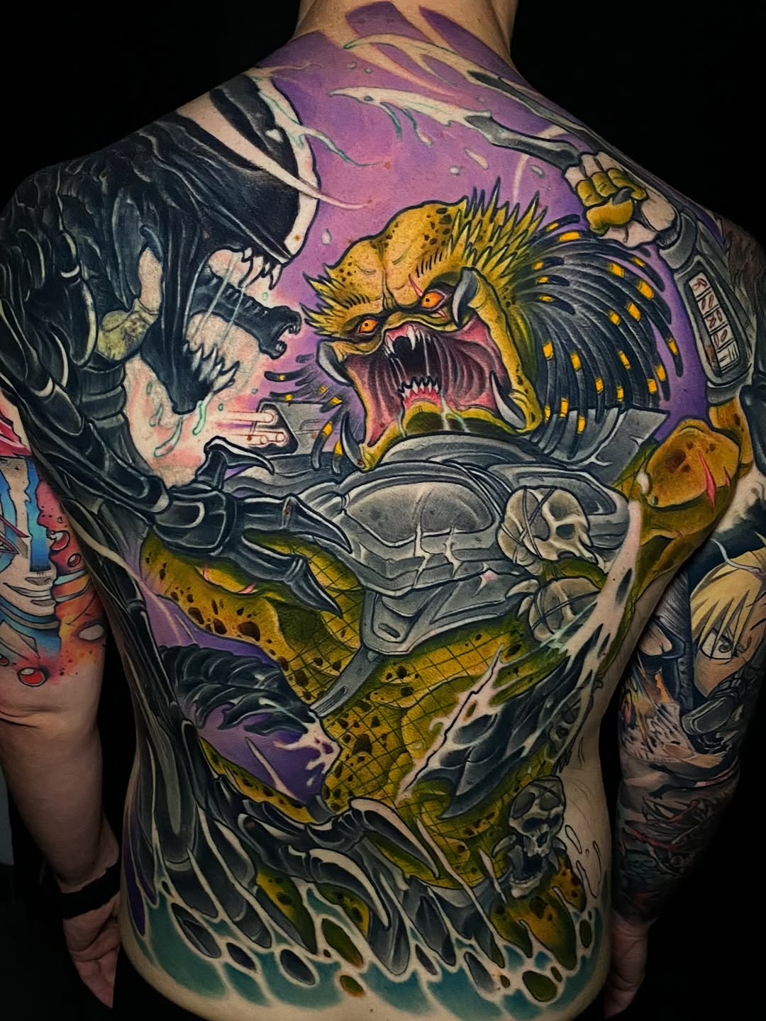 Colorful back tattoo featuring a winged dragon with open mouth, skull, armor plating, and yellow-green scales against a purple background.
