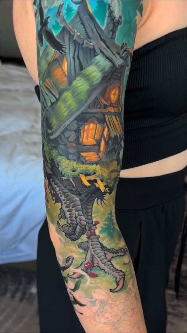 Colorful sleeve tattoo featuring a dragon with green and yellow scales, orange lanterns, turquoise sky, and ornamental details on the upper arm.