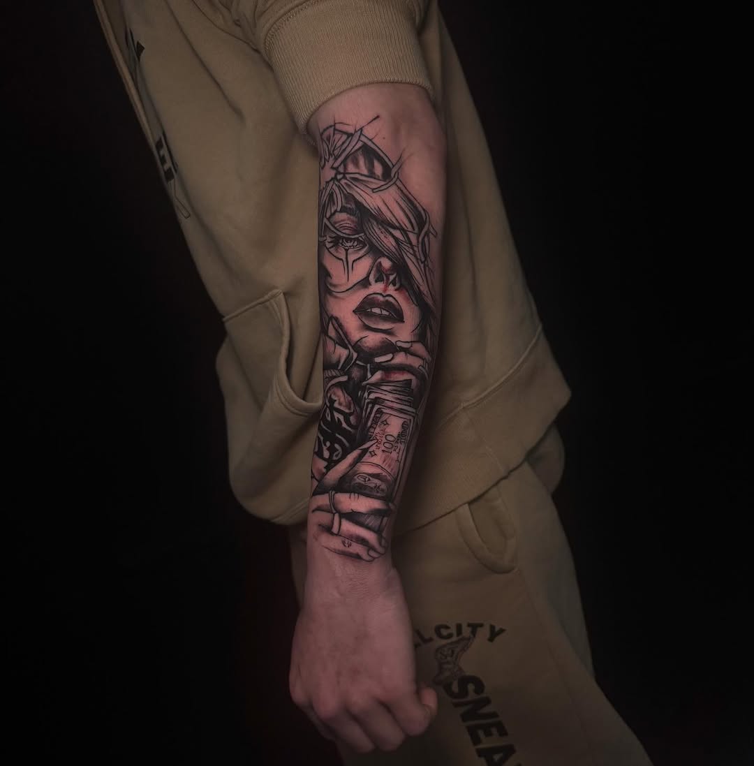Detailed portrait tattoo on the forearm featuring a woman's face with ornate headpiece and additional facial imagery, rendered in black and red ink.