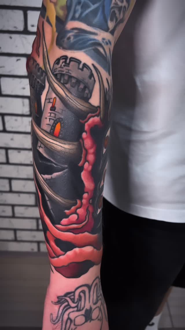 Colorful sleeve tattoo featuring a robotic astronaut head with red and orange accents, mechanical details, and blue elements on the upper arm.