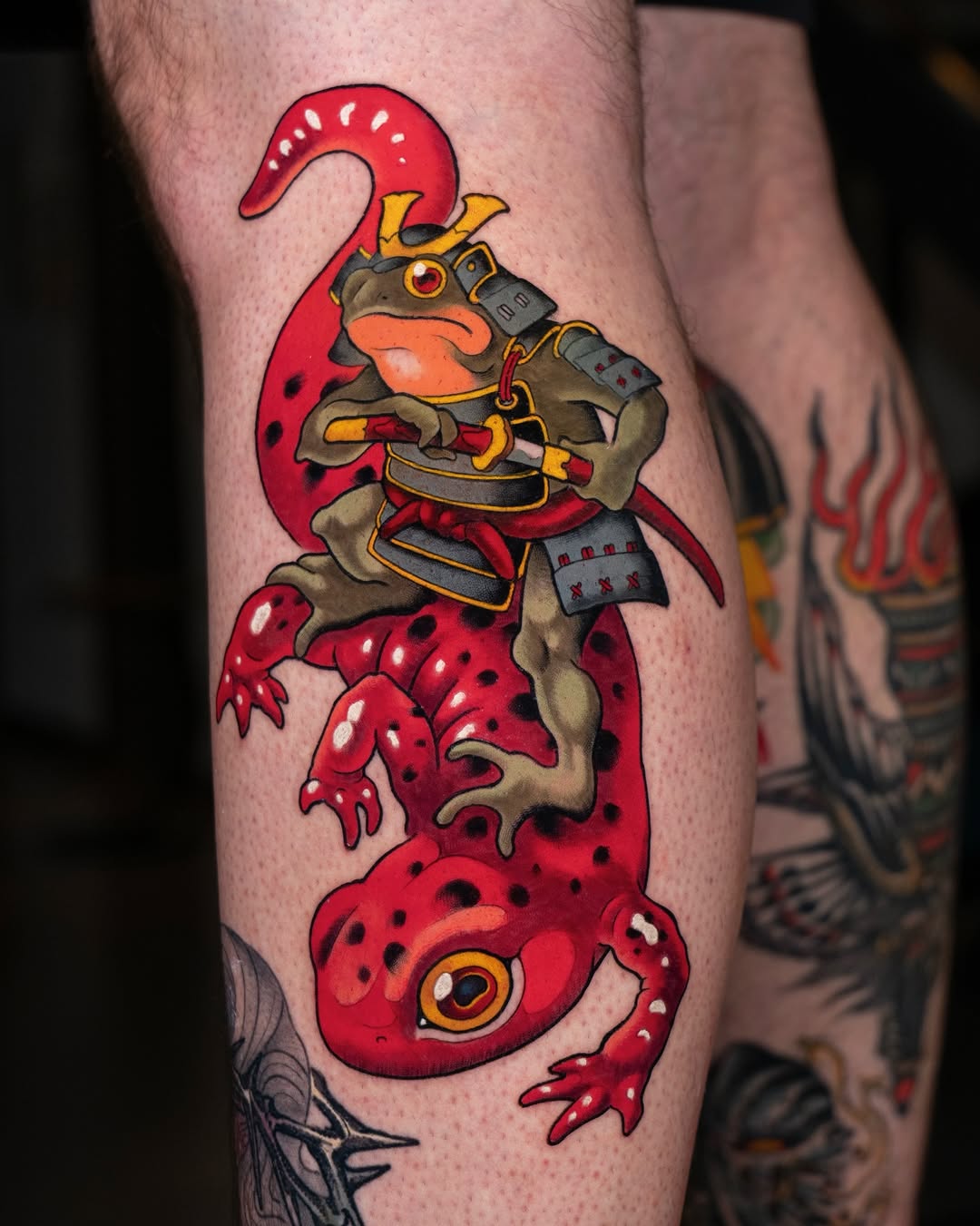 Red octopus creature with brown armor and weapons wrapped around human leg, featuring yellow and black accents.